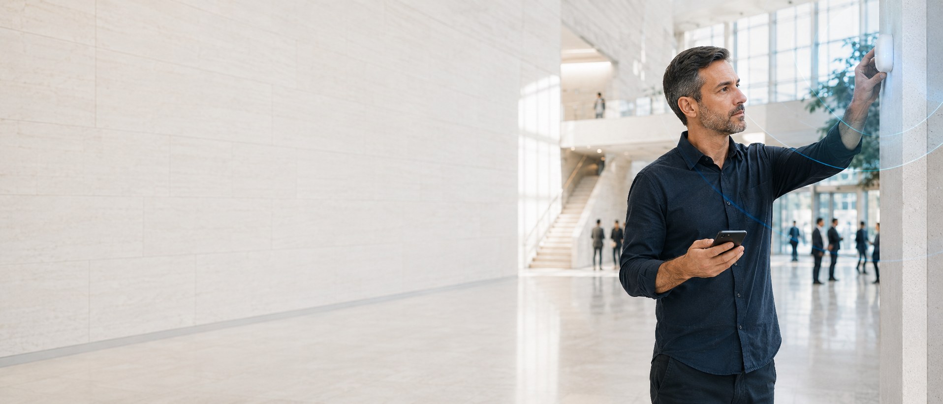 A technician testing a discreet Bluetooth beacon in a modern public venue